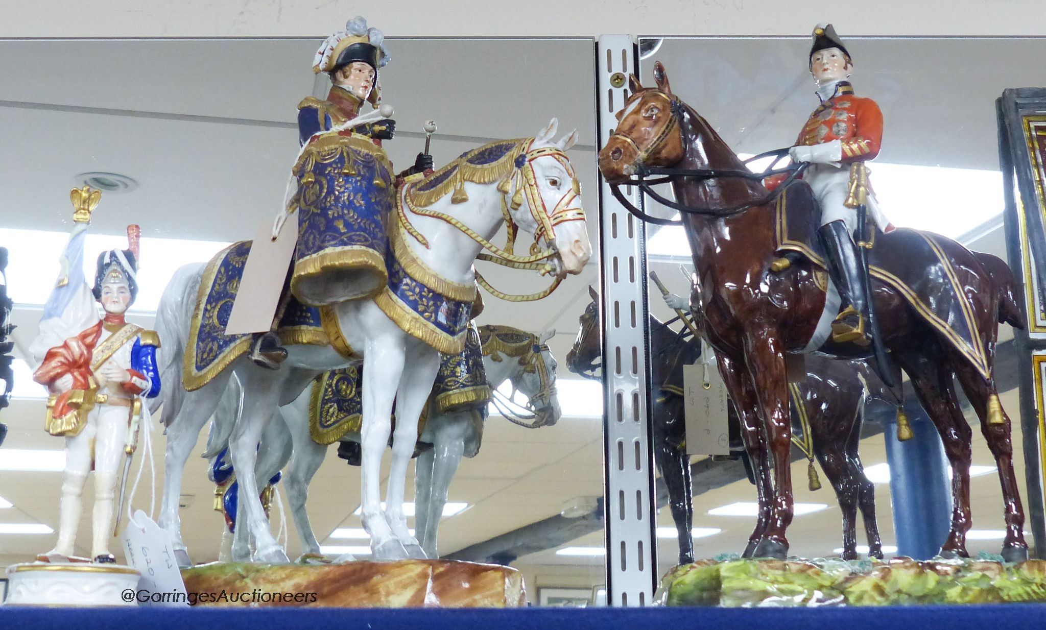 A large Dresden porcelain Waterloo Centenary equestrian group of the Duke of Wellington, retailers mark of Thomas Goode & Co and a similar equestrian group, 'Timbalier des Grenadiers a Cheval', pseudo mark, and an anothe